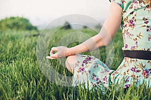 Pretty woman meditate in the park