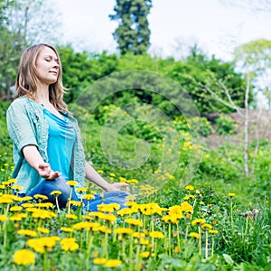 Pretty woman meditate in the park