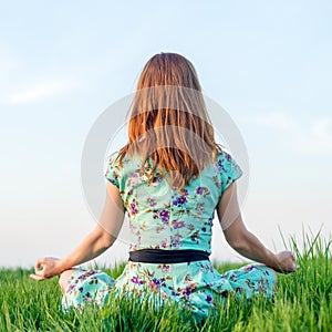 Pretty woman meditate in the park