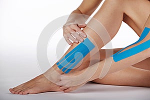 Pretty woman naked with sports taping on the body