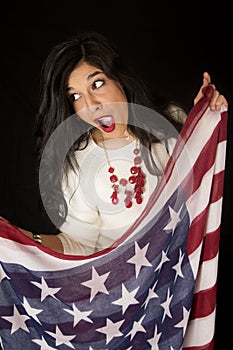 Pretty woman with an open mouth expression holding American flag