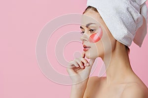 pretty woman pink patches on the face with a towel on the head close-up Lifestyle