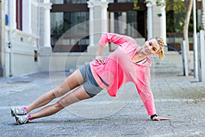 Pretty woman planking on the floor photo