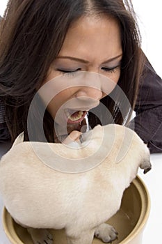 Pretty woman playing with puppy