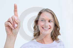 Pretty woman pointing with her finger