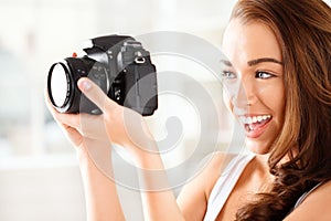 Pretty woman is a proffessional photographer with dslr camera