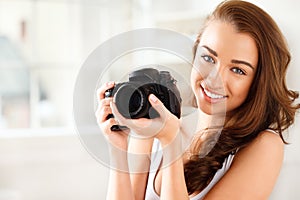 Pretty woman is a proffessional photographer with dslr camera