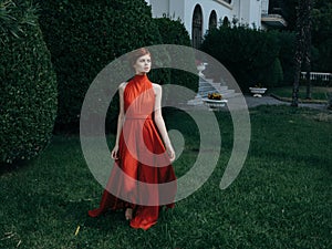 Pretty woman red dress walking luxury model outdoors