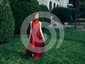 Pretty woman red dress walking luxury model outdoors