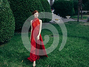 Pretty woman red dress walking luxury model outdoors