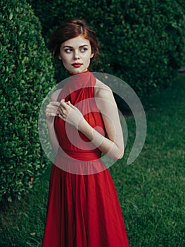 Pretty woman red dress walking luxury model outdoors