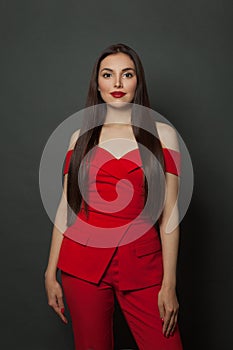 Pretty woman in red jumpsuit on black background