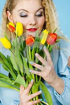 Pretty woman with red yellow tulips bunch