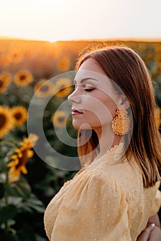 Pretty woman in retro dress posing in sunflowers field. Yellow colors, warm toning. Vintage timeless fashion, amazing