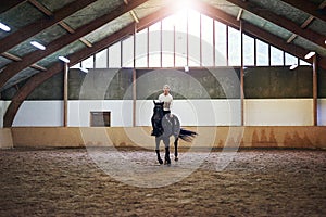 Pretty woman riding a brown horse