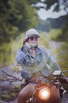 pretty woman riding sport enduro motorcycle on dirt field