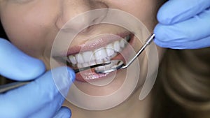 Pretty woman`s teeth examining in dental clinic