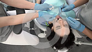 Pretty woman`s teeth treatment in dental clinic