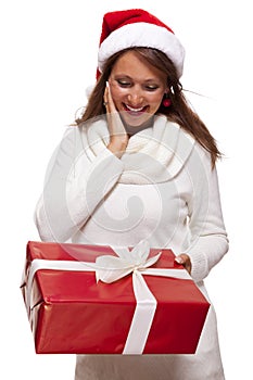 Pretty woman in a Santa hat with a large gift