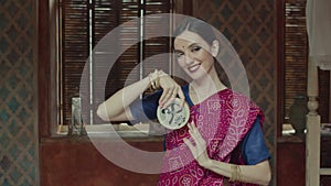 Pretty woman in sari holding meditative instrument