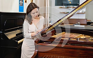 Pretty woman seller in piano music store