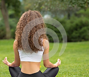 Pretty woman sitting back doing yoga meditation