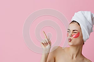 pretty woman skin care face patches bare shoulders pink background