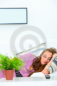 Pretty woman sleeping on divan at home
