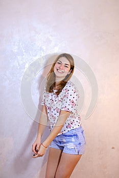 Pretty woman with smile posing on camera, standing on background