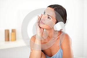 Pretty woman smiling while listening to music