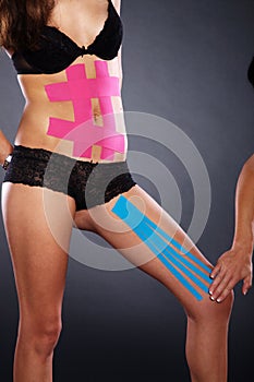 Pretty woman with sports taping on the body