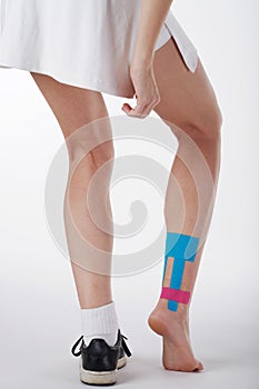 Pretty woman with sports taping on the body