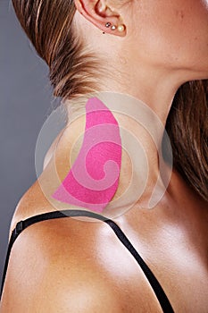 Pretty woman with sports taping on the body