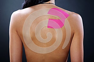 Pretty woman with sports taping on the body