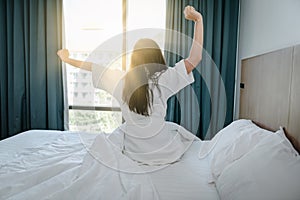 Pretty Woman Stretching in Her Bed After Wake Up in The Morning, Young Woman Having Relax During Waking Up on Bedroom. Beautiful