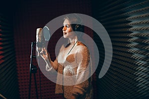 Pretty woman in stylish outfit recording her firt hit