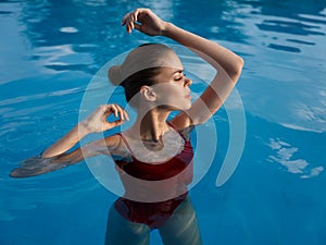 pretty woman swimsuit in swimming pool luxury hand gestures nature