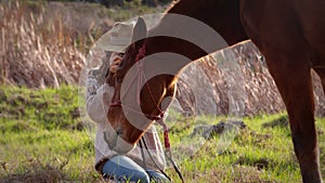 Pretty woman taking pictures of a horse