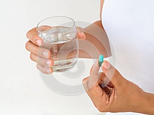 Pretty woman taking pill on white background. Healthcare and med