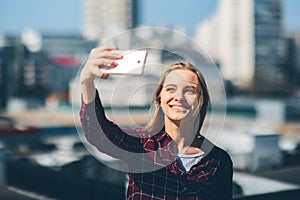 Pretty woman taking a selfie. Beautiful girl walking on the streets and photographing some landmarks. Blonde taken