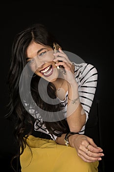 Pretty woman talking on her cell phone laughing