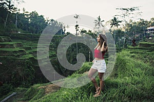 Pretty woman in tegalalang rice terrace fields in morning sunrise, Ubud, Bali, Indonesia.