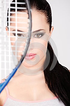 Pretty woman with tennis racket