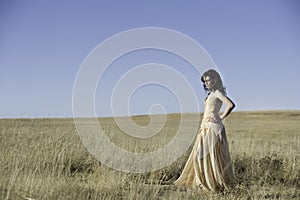 Pretty woman walking in golden field