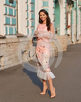 Pretty woman wearing elegant pink dress