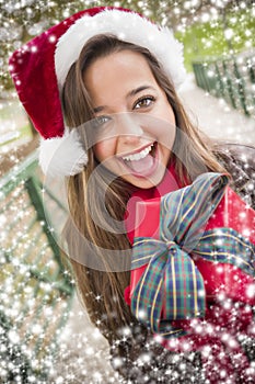 Pretty Woman Wearing a Santa Hat with Wrapped Gift