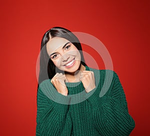 Pretty woman wearing warm sweater on background