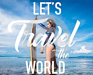 pretty woman in wetsuit with surfboard posing in ocean at Nusa dua Beach Bali Indonesia