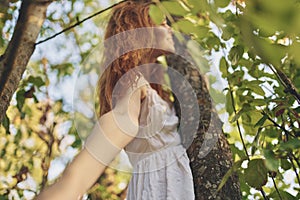 pretty woman in white dress nature green leaves of a tree bottom view