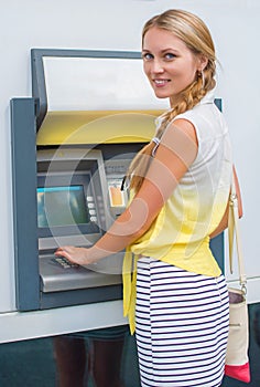 Pretty woman withdrawing money. photo